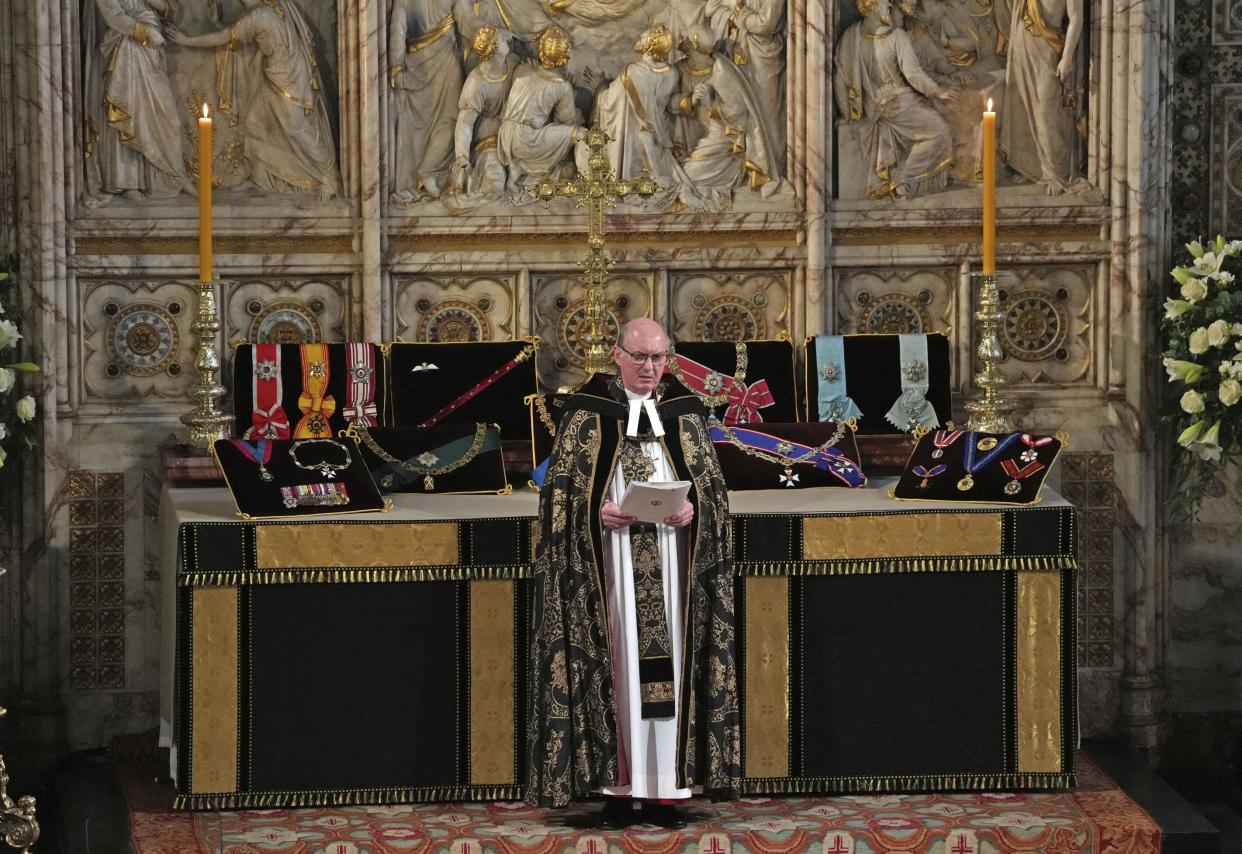 The medals and decorations of Prince Philip are displayed, as The Rt Revd David Conner, Dean of Windsor, looks on during the funeral for Britain Prince Philip at St George's Chapel in Windsor Castle, Windsor, England, Saturday April 17, 2021.