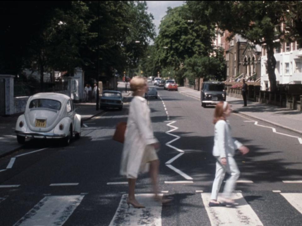 Elizabeth and Hallie walking across the street like the cover of Abbey Road.