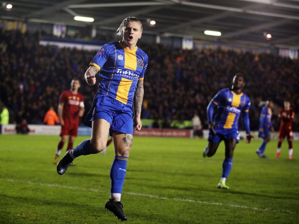 Jason Cummings celebrates scoring Shrewsbury's first goal: Reuters