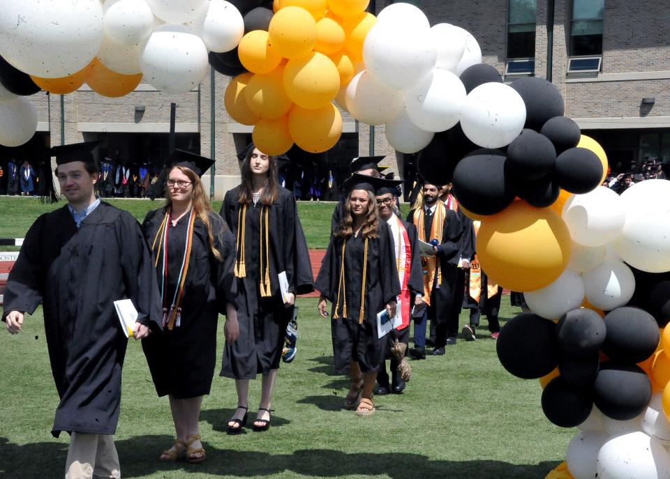 More than 400 College of Wooster seniors enter the stadium for the 152nd commencement. The ceremony was delayed by rain and pressed on despite a generator issue.