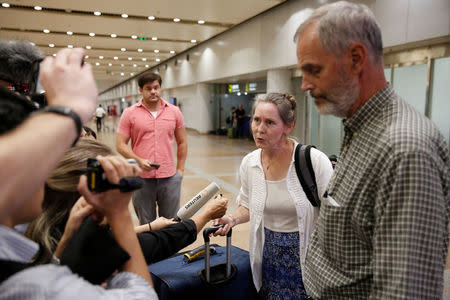 Aid workers Heidi Linton (2nd R) and Rob Robinson (R) of Christian Friends of Korea talk to the media after their arrival from Pyongyang at Beijing airport, China August 31, 2017. REUTERS/Thomas Peter