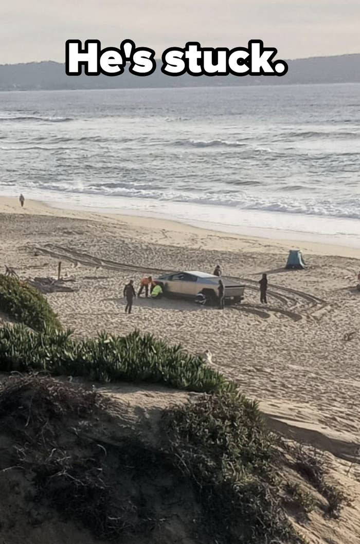 People on a beach with a boat; some are walking while others stand near the boat