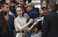 <p>Lily Collins, a cast member in “Tolkien,” signs autographs at the premiere of the film at the Regency Village Theatre, Wednesday, May 8, 2019, in Los Angeles. (Photo by Chris Pizzello/Invision/AP) </p>