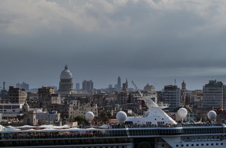 Passengers fill the top of The Empress of the Seas, a Royal Caribbean vessel, as it navigates out of the harbor in Havana, Cuba, Wednesday, June 5, 2019. Major cruise lines on Wednesday immediately began dropping stops in Cuba from their itineraries and hastily rerouting ships to other destinations including Mexico, after the Trump administration's new restrictions on travel to Cuba. (AP Photo/Ramon Espinosa)