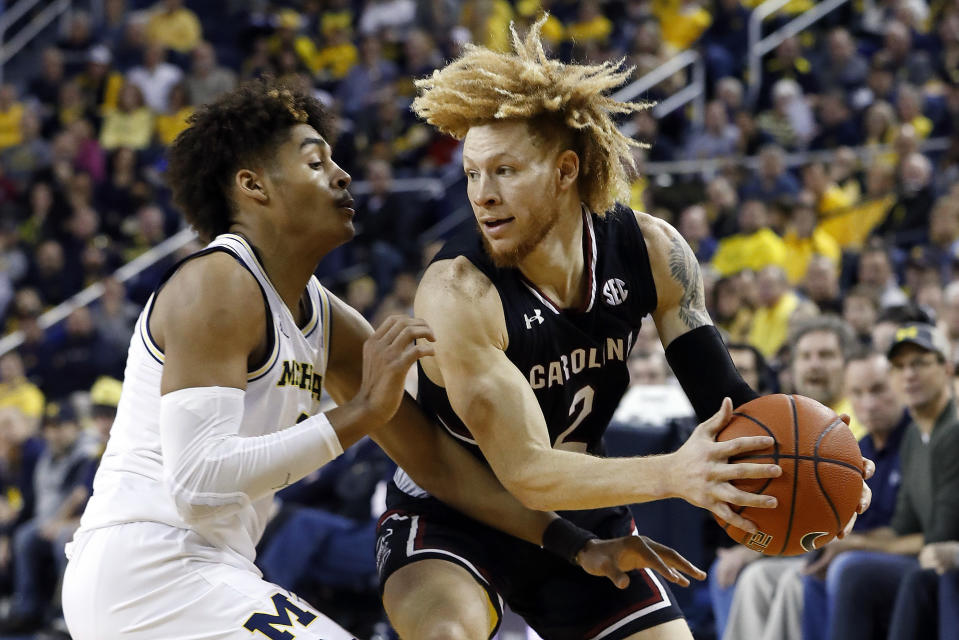 South Carolina guard Hassani Gravett (2) drives on Michigan guard Jordan Poole in the first half of an NCAA college basketball game in Ann Arbor, Mich., Saturday, Dec. 8, 2018. (AP Photo/Paul Sancya)