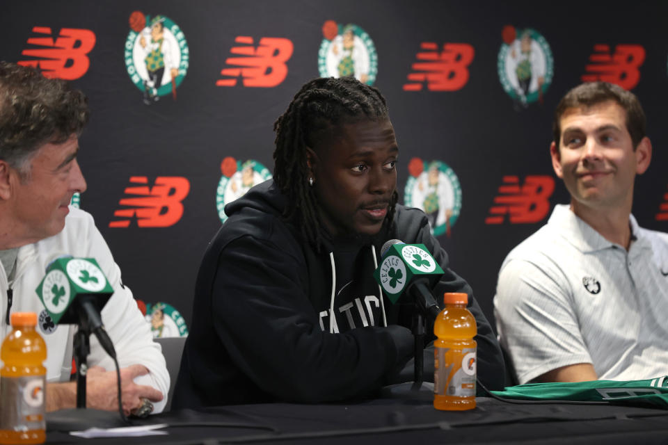 Boston, MA - October 3: Boston Celtics PG Jrue Holiday, center, speaks at his introductory press conference. He is flanked by team owner Wyc Grousbeck and President of Basketball Operations Brad Stevens. (Photo by Jonathan Wiggs/The Boston Globe via Getty Images)