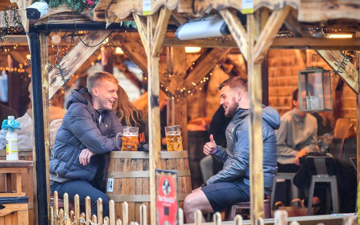 Last orders: People enjoy a beer in Cardiff - PA