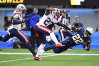 Los Angeles Chargers running back Justin Jackson (22) is tackled by New England Patriots cornerback J.C. Jackson (27) after a long run during the first half of an NFL football game Sunday, Oct. 31, 2021, in Inglewood, Calif. (AP Photo/John McCoy)