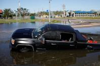 A submerged car is seen on a flooded street after Hurricane Delta, in Lake Charles