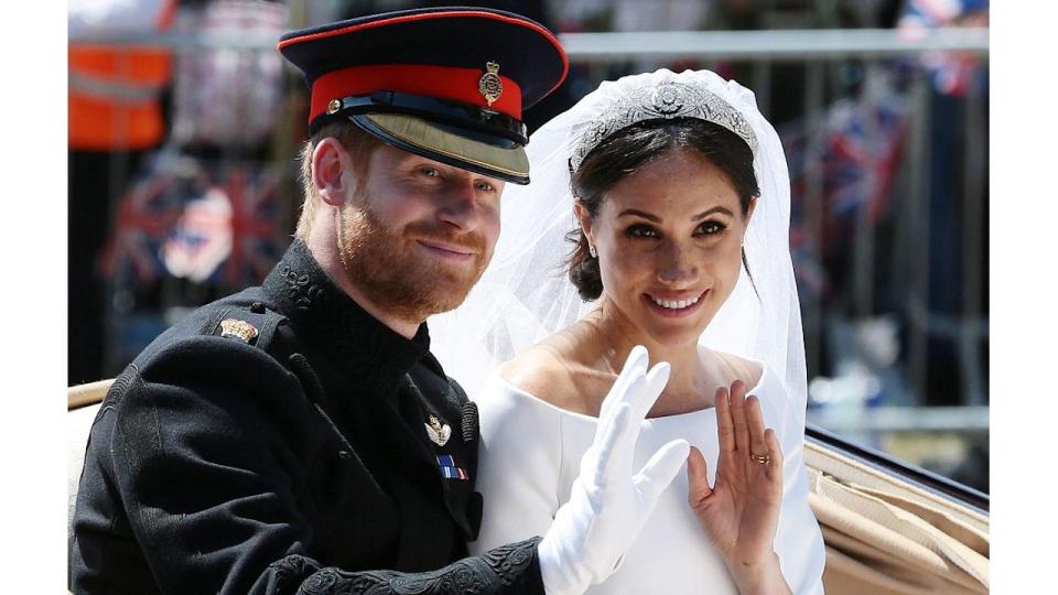 Prince Harry and Meghan waving from carriage on wedding day