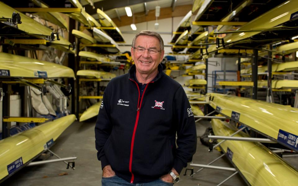 Jurgen Grobler poses next to row boats - HEATHCLIFF O'MALLEY