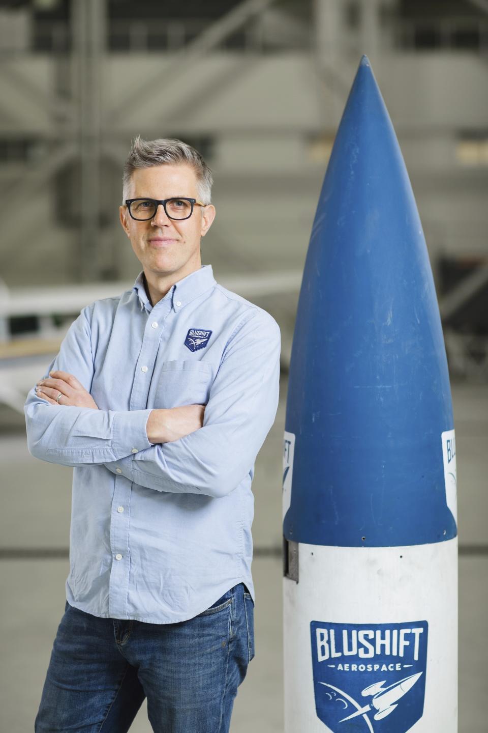 Sascha Deri, CEO and Founder of bluShift Aerospace, stands with Stardust 1.0 commercial rocket, April 2021 at bluShift headquarters in Brunswick, Maine. The company hopes to begin commercial launches of small satellites next year. (Lindsay Becker/bluShift Aerospace via AP)