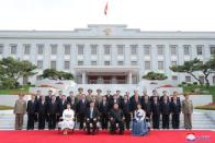 North Korean leader Kim Jong Un and wife Ri Sol Ju pose for a group photo with China's President Xi Jinping and wife Peng Liyuan along with North Korean officials during Xi's visit in Pyongyang, North Korea in this undated KCNA photo