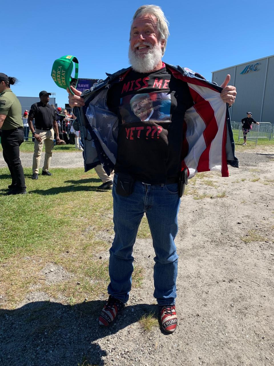 Edward Young shows off a Donald Trump shirt while waiting to enter the Aero Center at Wilmington International Airport in advance of a rally featuring the former president.