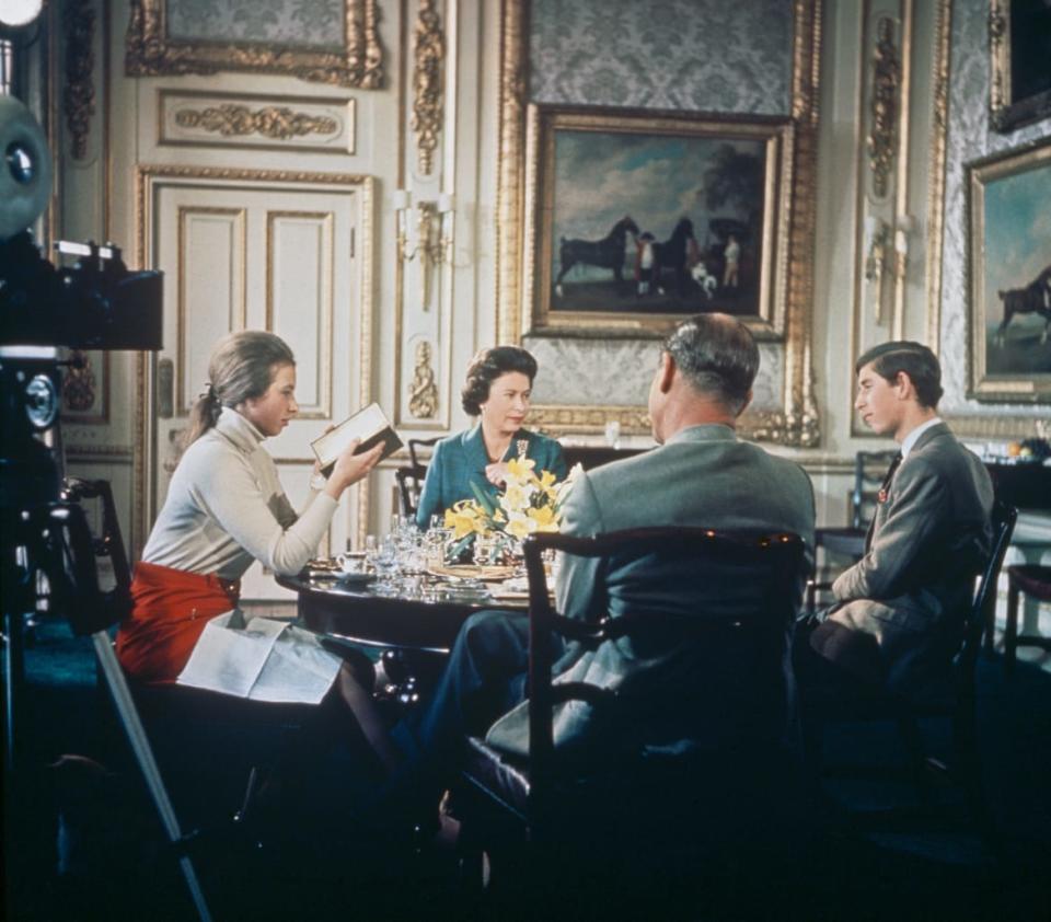 <div class="inline-image__caption"><p>Queen Elizabeth II lunches with Prince Philip and their children Princess Anne and Prince Charles at Windsor Castle in Berkshire, circa 1969, during a filming for Richard Cawston’s BBC documentary <em>Royal Family</em>, which followed the royal family over a period of a year.</p></div> <div class="inline-image__credit">Hulton Archive/Getty</div>