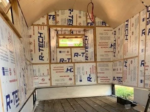 Insulation being put into the walls of the wagon