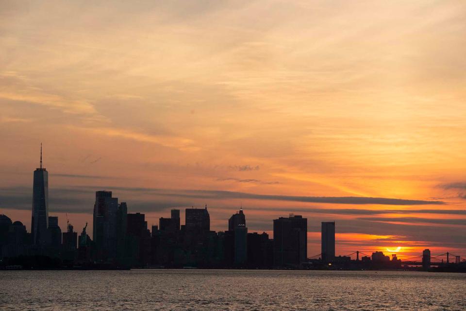 A solar eclipse rises behind the New York City Skyline on June 10, 2021. Approximately 80% of the sun was blocked by the moon.