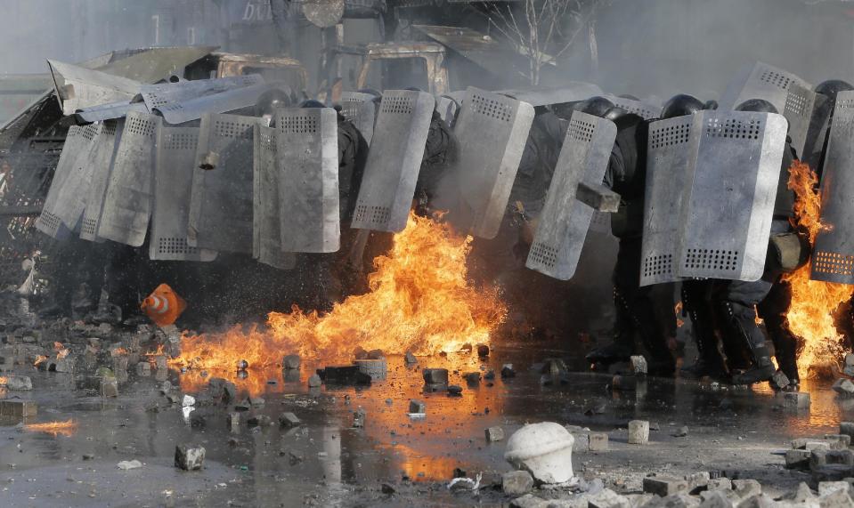 Riot police clash with anti-government protesters outside Ukraine's parliament in Kiev, Ukraine, Tuesday, Feb. 18, 2014. Some thousands of anti-government protesters clashed with police in a new eruption of violence Tuesday. (AP Photo/Efrem Lukatsky)