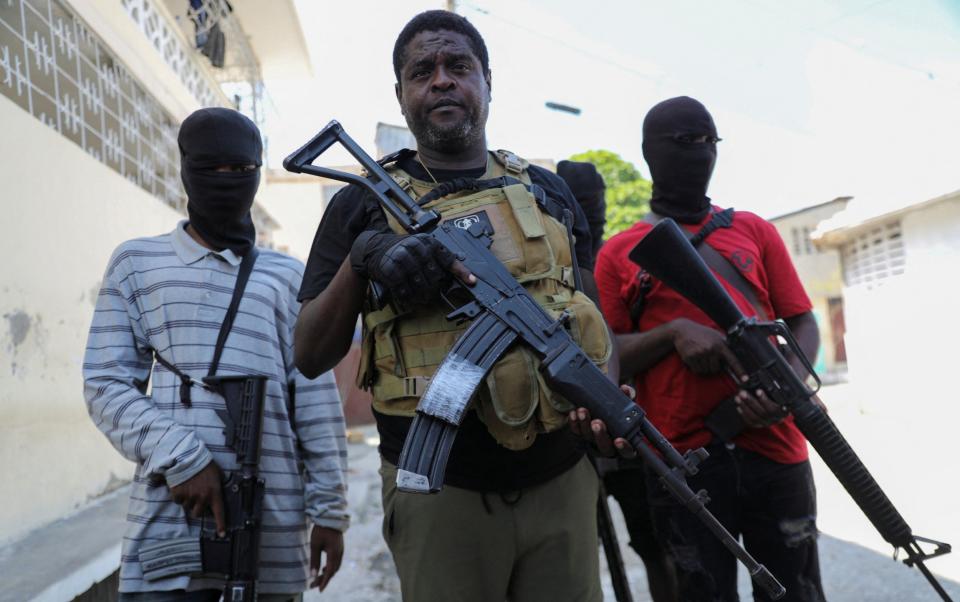 'Barbecue' grilled ... Jimmy Chérizier, centre, in Port-au-Prince on Tuesday