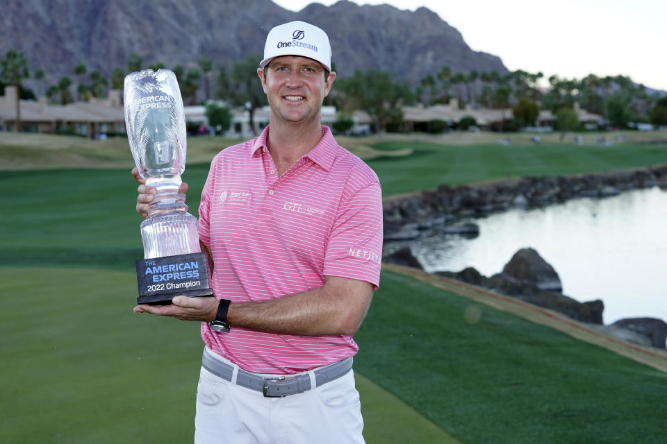 Hudson Swafford holds the winner's trophy at the end of the American Express golf tournament on the Pete Dye Stadium Course at PGA West, Sunday, Jan. 23, 2022, in La Quinta, Calif. (AP Photo/Marcio Jose Sanchez)