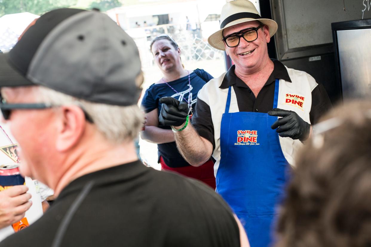 Carl Pfeiffer head cook with the Swine & Dine team gives a tour of their tent during the Kingsford Tour of Champions at the Memphis in May World Championship Barbecue Cooking Contest on May 16, 2019.