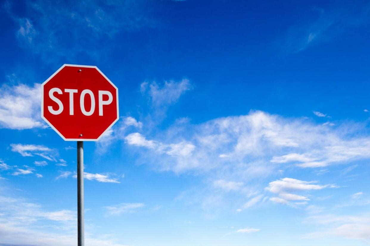 Stop sign and blue sky with clouds.