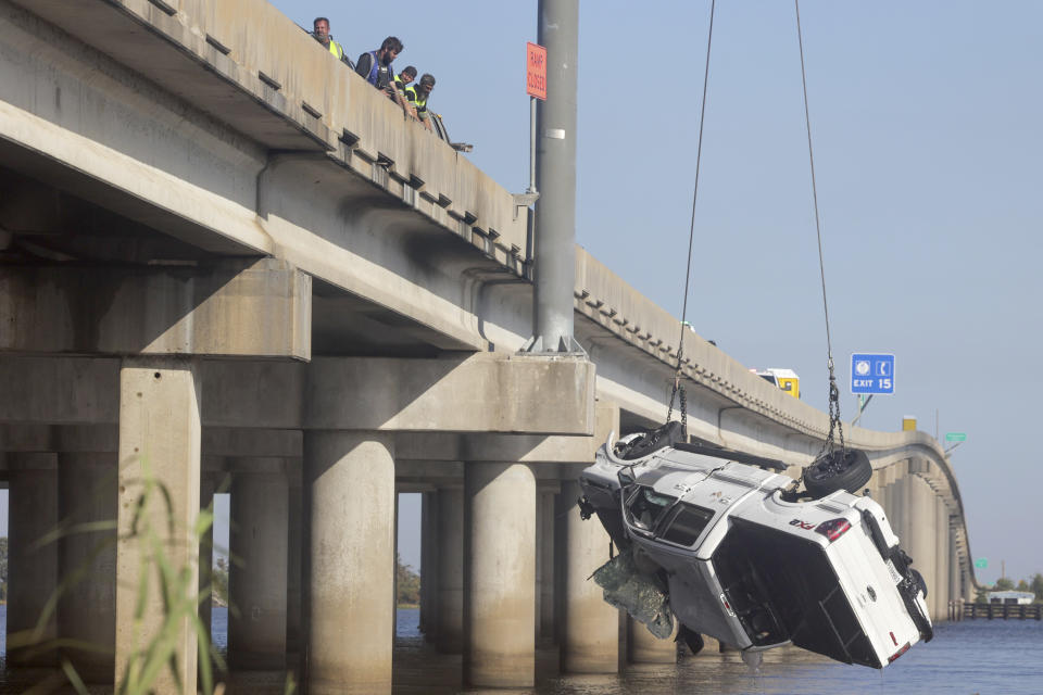 A vehicle is lifted out of Lake Maurepas under Interstate-55 near Manchac, Tuesday, October 24, 2023. Authorities say at least seven people were killed Monday after a “superfog” of smoke from south Louisiana marsh fires and dense fog caused multiple massive car crashes involving 158 vehicles.(Brett Duke/The Times-Picayune/The New Orleans Advocate via AP)