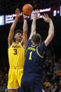 Minnesota forward Dawson Garcia (3) shoots over Michigan center Hunter Dickinson (1) during the first half of an NCAA college basketball game Thursday, Dec. 8, 2022, in Minneapolis. (AP Photo/Bruce Kluckhohn)