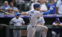 Los Angeles Dodgers' Trea Turner follows the flight of his RBI-single off Colorado Rockies relief pitcher Carlos Estevez in the ninth inning of a baseball game Thursday, Sept. 23, 2021, in Denver. (AP Photo/David Zalubowski)