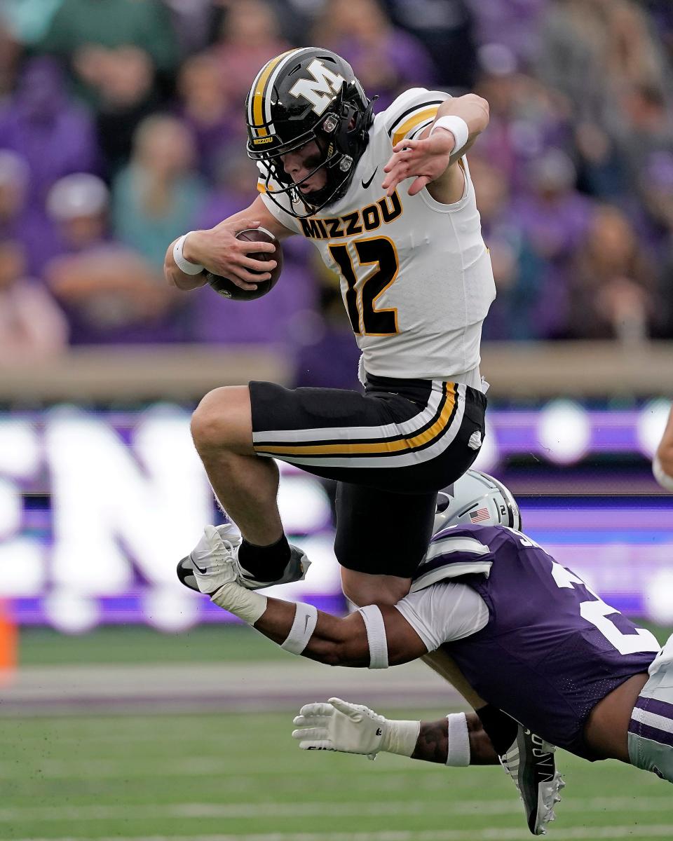 Missouri quarterback Brady Cook (12) is tackled by Kansas State safety Kobe Savage during a Sept. 10 game in Manhattan, Kan.