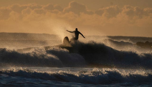 Surfers at Tynemouth Longsands beach on the North East coast.