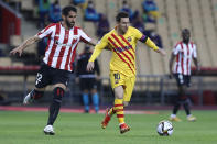 Barcelona's Lionel Messi fights for the ball against Athletic Bilbao's Raul Garcia during the Spanish Copa del Rey final 2021 between Athletic Bilbao and Barcelona at La Cartuja stadium in Seville, Spain, Saturday April 17, 2021. (AP Photo/Angel Fernandez)