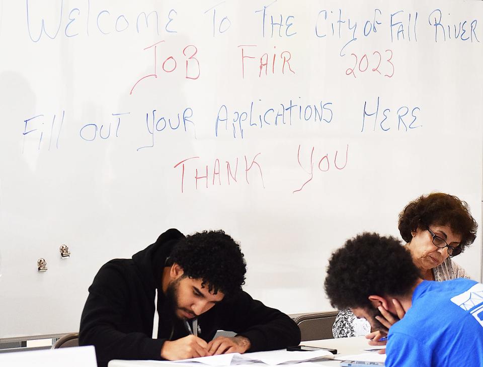 Participants fill out applications at the Fall River Job Fair held at Government Center on Wednesday, Aug. 30.