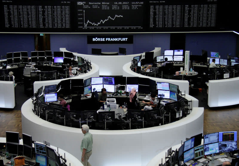 Traders work in front of the German share price index, DAX board, at the stock exchange in Frankfurt, Germany, August 18, 2017. REUTERS/Staff/Remote