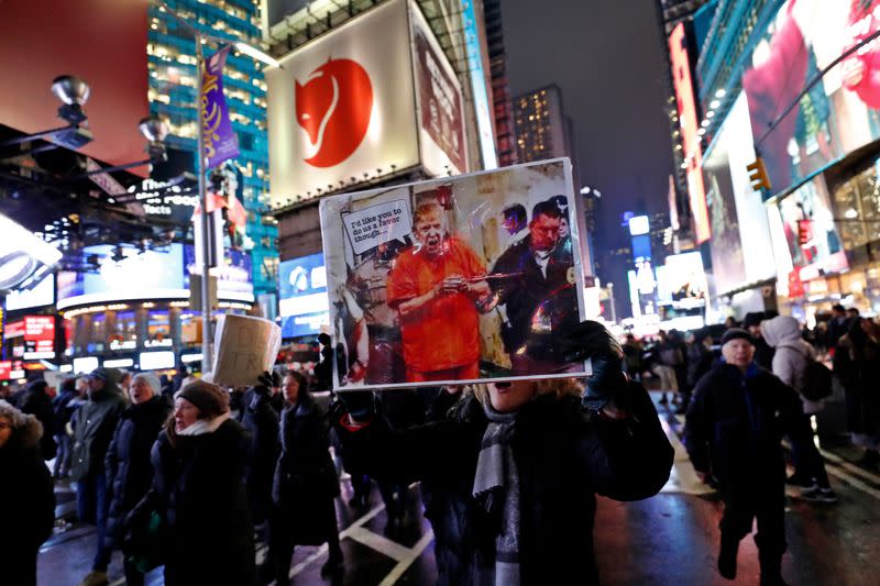 Demonstrators gather to demand the impeachment and removal of U.S. President Donald Trump during a rally at Times Square in New York City