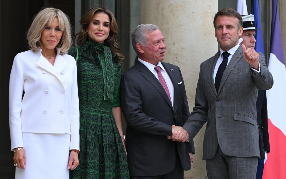 PARIS, FRANCE - JUNE 24 Jordan's King Abdallah II (2ndR) is welcomed by France's President Emmanuel Macron (R) as Jordan's Queen Rania (3rdR) and French first lady Brigitte Macron (C) look at Elysee Palace on June 24, 2024 in Paris, France. (Photo by Christian Liewig - Corbis/Corbis via Getty Images)