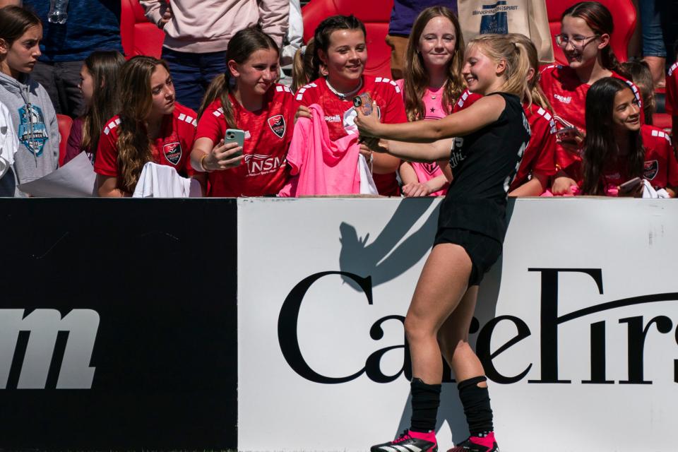 Washington Spirit midfielder Chloe Ricketts takes a selfie with fans following a NWSL soccer match against the San Diego Wave on May 6.