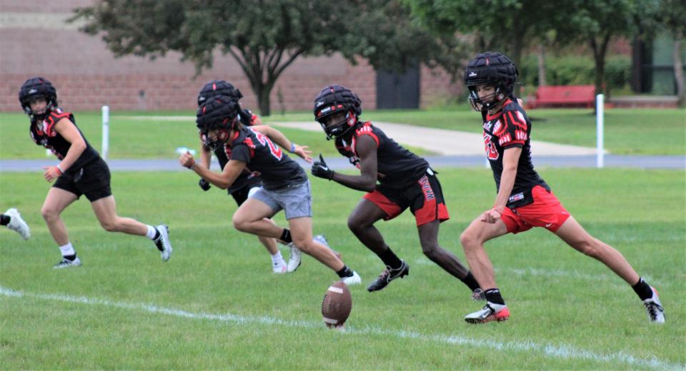 Milan's Adam Johnson (right) takes the kickoff during special teams drills on the opening day of football practice Monday, August 7, 2023.