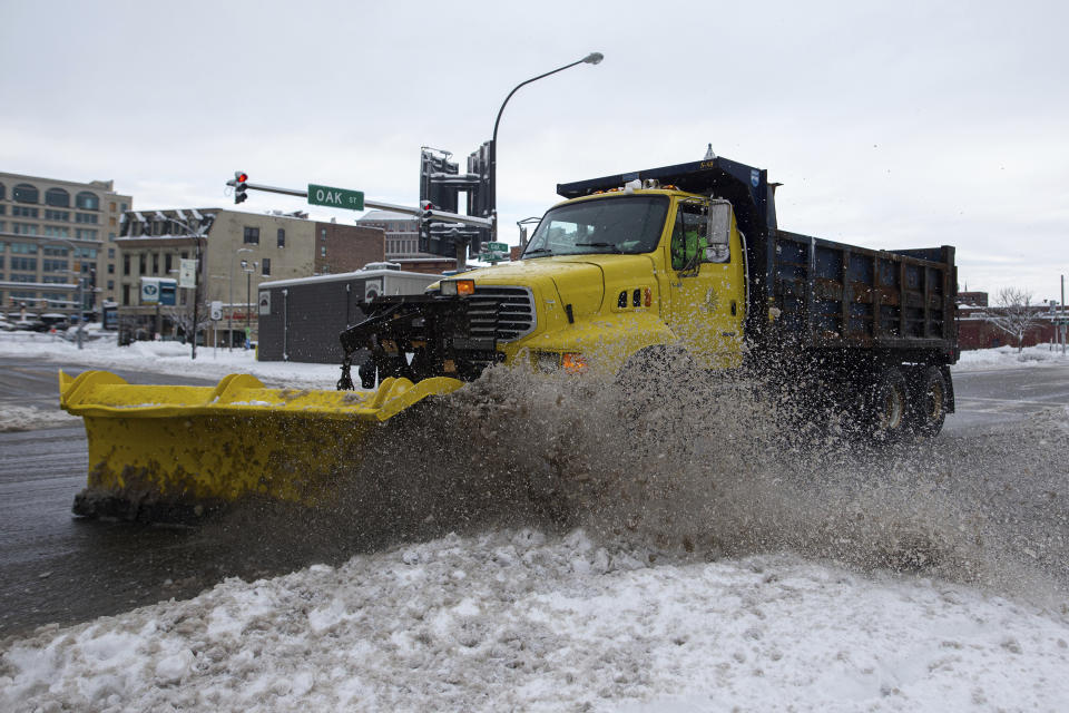 A snow plow clears snow from the road on Friday, Nov. 18, 2022, in Buffalo, N.Y. A dangerous lake-effect snowstorm paralyzed parts of western and northern New York, with nearly 2 feet of snow already on the ground in some places and possibly much more on the way. (AP Photo/Joshua Bessex)