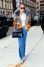 <p>In a colorblock fur coat, cropped white tee, two-toned flared jeans, white snakeskin boots, a Mansur Gavriel bag and round tortoise shell sunglasses by Krewe while out in New York.</p>