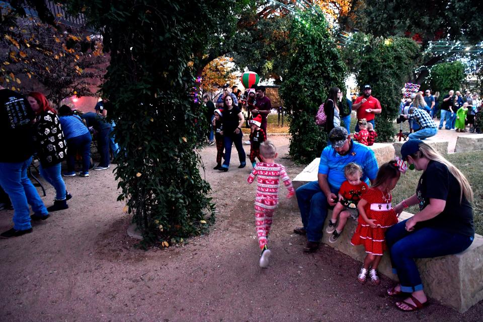 A boy in his pajamas races through the Adamson-Spalding Storybook Garden. Families were encouraged to don their sleepwear for "Christmas in the Garden."