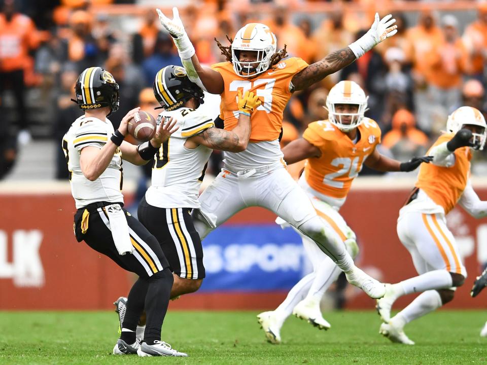 Missouris defensive back Dreyden Norwood (20) protects quarterback Brady Cook (12) from Tennessee linebacker Jeremy Banks (33) during an NCAA college football game against on Saturday, November 12, 2022 in Knoxville, Tenn. 