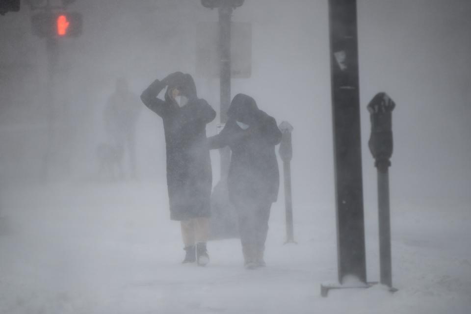 People protect themselves from blowing wind and snow during white-out conditions as Winter Storm Kenan bears down on Jan. 29, 2022, in Boston.
(Photo: Scott Eisen, Getty Images)