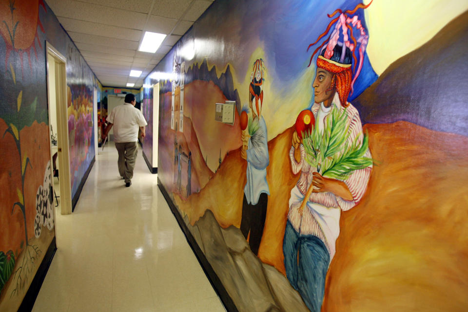 FILE - In this May 29, 2008, file photo, colorful murals line the walls at the Indian Health Services clinic at San Xavier Health complex just south of Tucson, Ariz. About 120,000 Arizona residents who receive Medicaid benefits will have to get a job, do community service or temporarily lose health coverage. The Centers for Medicare and Medicaid Services approved the state's plan Friday, Jan.18, 2019. The Trump administration has urged states to consider changes to their Medicaid programs to encourage work and independence. Others say it unfairly targets the working class. (Greg Bryan/Arizona Daily Star via AP, File)