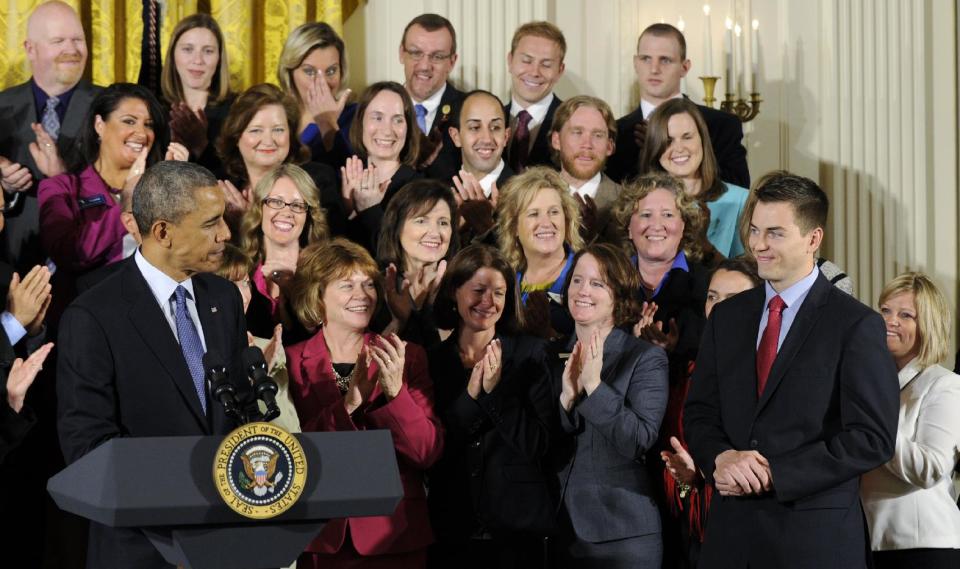 President Obama and 2014 National Teacher of the Year finalists applaud Sean McComb, second from right, a high school English teacher from Maryland who helps push students toward college, as the 2014 National Teacher of the Year, Thursday, May 1, 2014, during an event in the East Room of the White House in Washington. (AP Photo/Susan Walsh)