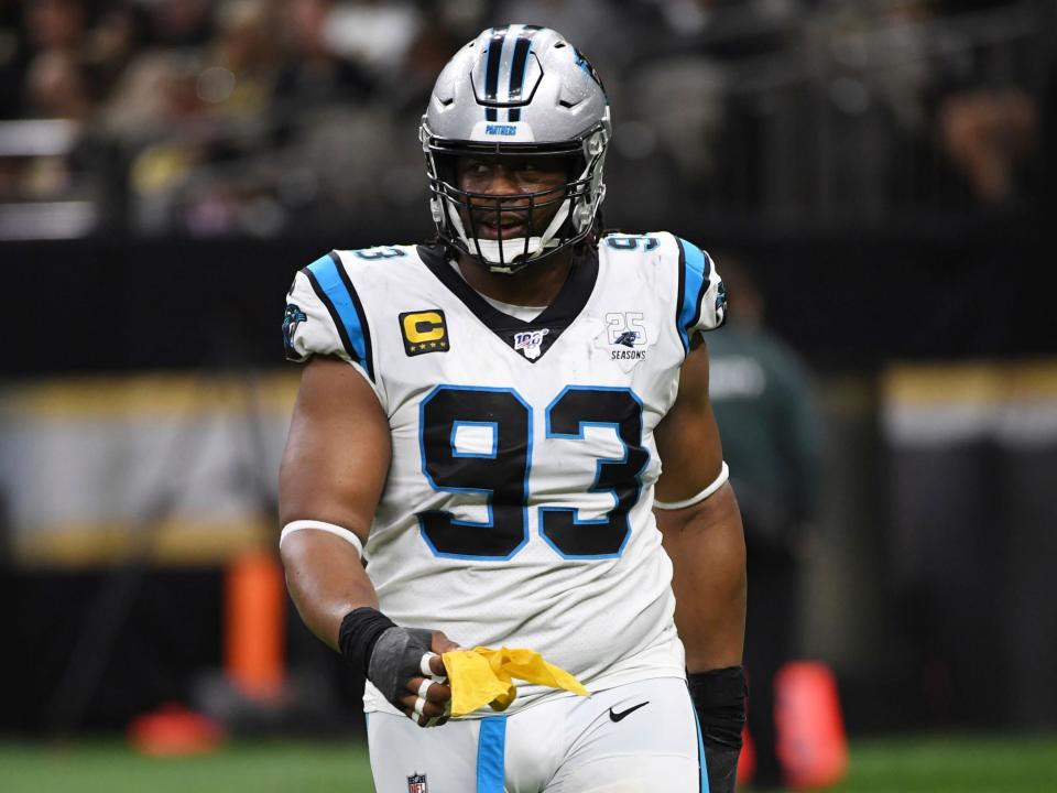 Gerald McCoy holds a penalty flag.