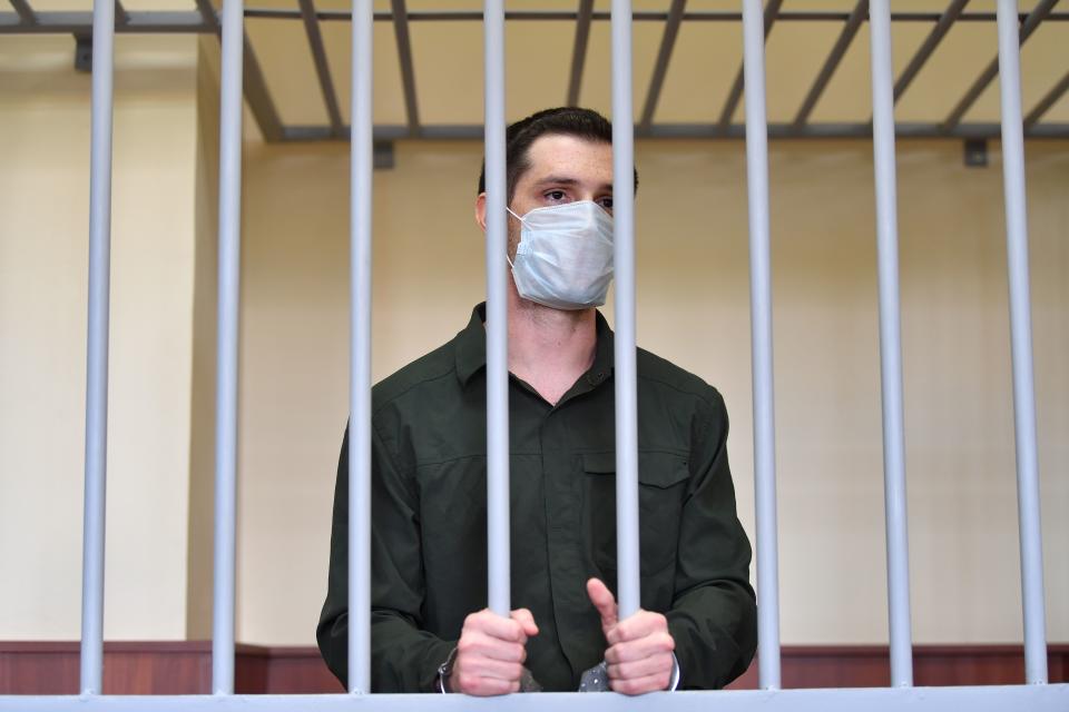 US ex-marine Trevor Reed, charged with attacking police, stands inside a defendants' cage during his verdict hearing at Moscow's Golovinsky district court on July 30, 2020. (Photo by Dimitar DILKOFF / AFP) (Photo by DIMITAR DILKOFF/AFP via Getty Images)