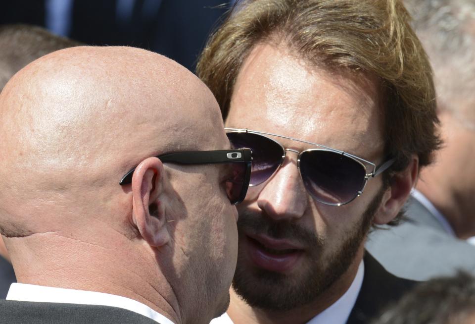 Formula One driver Jean-Eric Vergne (R) speaks with Philippe Bianchi, father of Jules Bianchi, during the funeral ceremony for late Marussia F1 driver Jules Bianchi at the Sainte Reparate Cathedral in Nice, France, July 21, 2015. Bianchi, 25, died in hospital in Nice on Friday, nine months after his crash at Suzuka in Japan and without regaining consciousness. REUTERS/Jean-Pierre Amet