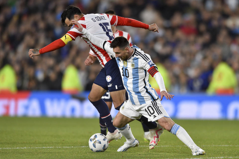 Argentina's Lionel Messi battles for the ball with Paraguay's Gustavo Gomez during a qualifying soccer match for the FIFA World Cup 2026 at the Monumental stadium in Buenos Aires, Argentina, Thursday, Oct. 12, 2023. (AP Photo/Gustavo Garello)