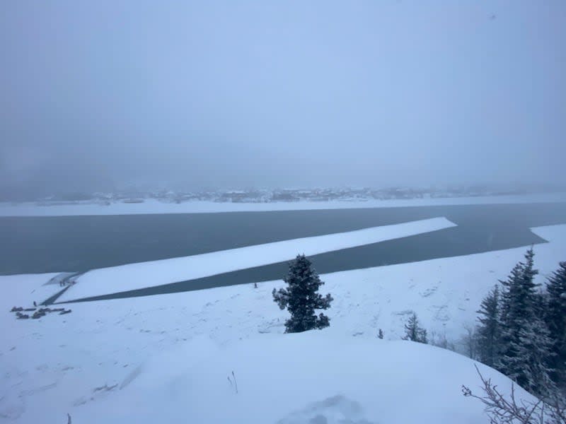 Duncan Smith of Dawson City, Yukon, helped to cut an enormous slab of ice on the weekend — then watched as it floated away instead of lodging across the river. Residents are still waiting for the river to freeze over and a government-sanctioned crossing to open. (Duncan Smith - image credit)
